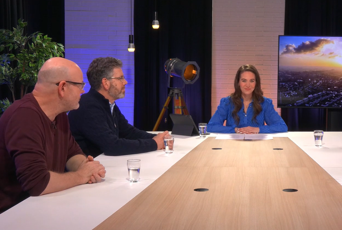 Presentator en deskundigen aan een tafel tijdens het webinar over de isolatieaanpak